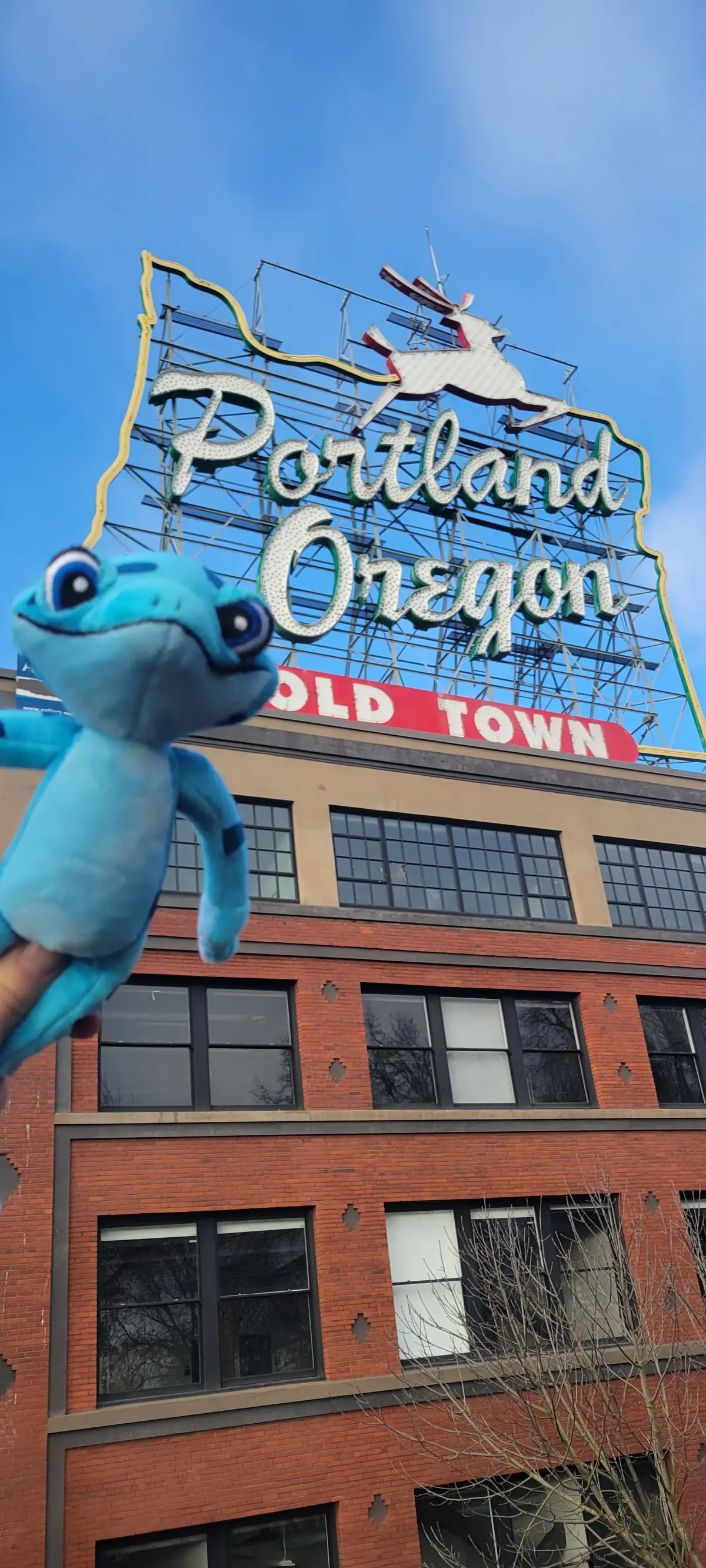 Freddie the bluefrog mascot at the iconic Portland Oregon sign
